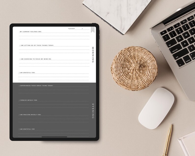 May include: A digital planner on a tablet screen with a gray background. The planner is divided into two sections: Morning and Evening. Each section has prompts for reflection and gratitude. The text on the screen reads "My current feelings are", "I am letting go of these things today", "I am choosing to focus my mind on", "I am grateful for", "I experienced these great things today", "Forgiving myself for", "I am praising myself for", "I am grateful for".