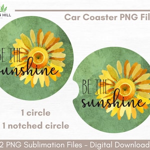 May include: Two round car coasters with a green background and a watercolor sunflower design. The text "BE THE SUNSHINE" is written in black on each coaster.