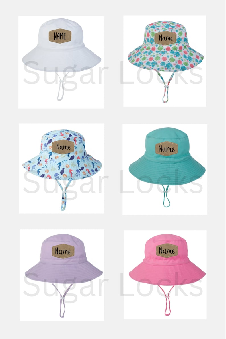 May include: Set of five sun hats with different patterns and colors. Each hat has a brown patch with the word "Name" written in black. The hats are white, pink, light blue, purple, and a floral pattern.