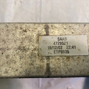 May include: A white label with black text that reads "SAAB 4729521 10/12/02 22:41 ETP8935".