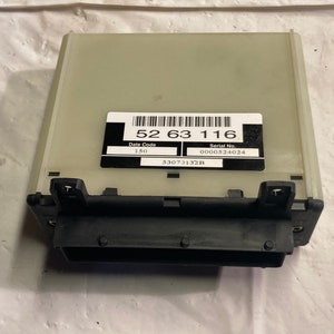 May include: A beige electronic control unit with a black label that reads "52 63 116", "Date Code 150", "Serial No. 0000524024", and "S307132B".