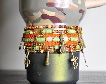 Camouflage Bracelet Stack with Music Charms: Gold, Brown, and Orange Charm Bracelets