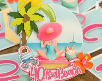 May include: A pink and white cake topper with a woman in a pink hat and swimsuit sitting on a beach with a palm tree, sunglasses, and a coconut. The text "40 is a Beach" is written in pink on the topper.
