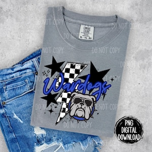 May include: A gray t-shirt with a blue and white graphic design featuring a bulldog wearing sunglasses and the text "Wardogs". The graphic also includes a checkered flag and a lightning bolt.