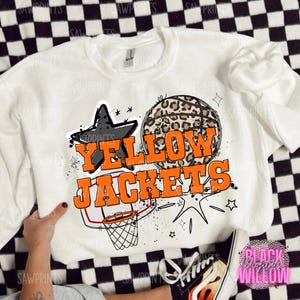 May include: White sweatshirt with a graphic design featuring a basketball with a leopard print, a black star, and the text "Yellow Jackets".