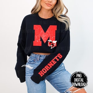 May include: A black cropped sweatshirt with red and white lettering that says "HORNETS" on the sleeve and a red "M" with a distressed look on the front. The "M" has a small red and black hornet graphic next to it.