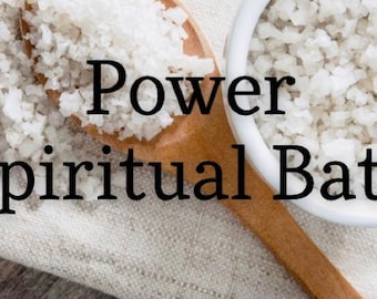 May include: White sea salt in a white bowl and a wooden spoon on a white linen cloth. The text "Power Spiritual Bath" is written in black on the cloth.