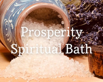 May include: A white ceramic jar with blue and white floral designs is tipped over, spilling out white bath salts. The text "Prosperity Spiritual Bath" is superimposed on the image.