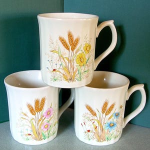 set of 3 1980&#39;s vintage Japanese floral design mugs ~ flowers, ladybugs, grasses ~ yellow, blue, pink