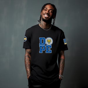 May include: Black t-shirt with the word "DOPE" in blue and white block letters. The letter "O" features a circular emblem with a tiger and the words "Florida State Seminoles". A small emblem is on the left sleeve.