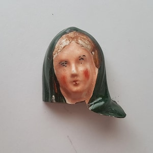 face of a statue, pottery shard, fragment, Mud larking, antique, collectable, mixed media display.