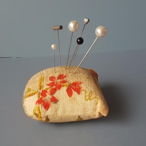 vintage pincushion,  with various pins