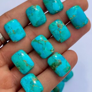 May include: A collection of ten polished, rectangular turquoise gemstones featuring vibrant sky-blue hues with natural brown matrix veining. Each stone has a smooth, rounded surface and a consistent shape, showcasing unique mineral patterns throughout.