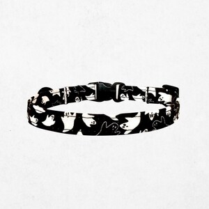 A black and white patterned dog collar is shown against a plain white background.