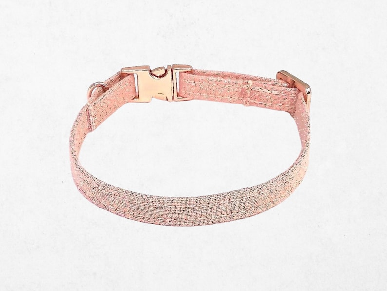A pink glittery dog collar with a buckle.
