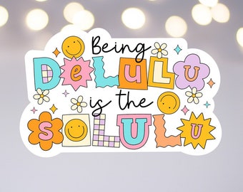 May include: A sticker with a colourful design that says "Being Delulu is the Solu
