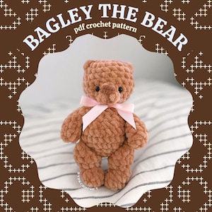 May include: A brown plush crochet bear with a light pink ribbon tied around its neck. The text reads BAGLEY THE BEAR pdf crochet pattern and @ Y2KCrochet Anti-AI Crochet Artist. The bear has small black eyes and a textured yarn finish.