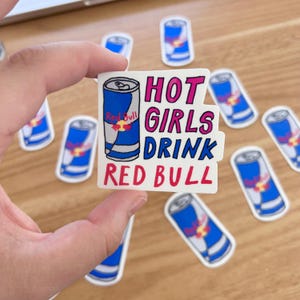 May include: A white sticker with a red bull can illustration and the text "HOT GIRLS DRINK RED BULL" in pink and red lettering.