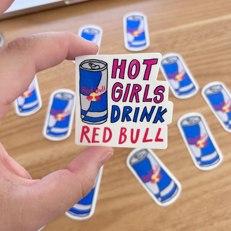May include: A white sticker with a red bull can illustration and the text "HOT GIRLS DRINK RED BULL" in pink and red lettering.