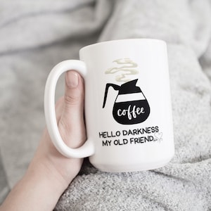 May include: White coffee mug with a black illustration of a coffee pot and the text "coffee" and "Hello darkness my old friend".
