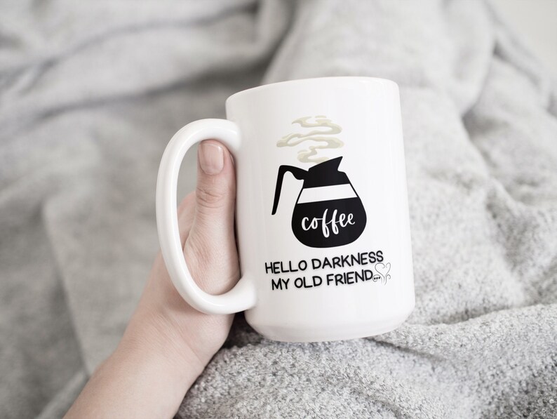 May include: White coffee mug with a black illustration of a coffee pot and the text "coffee" and "Hello darkness my old friend".