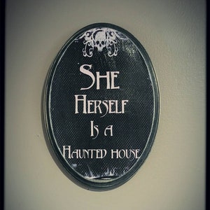 She herself is a haunted house plaque