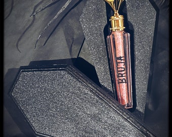 BRUJA  lipgloss ( glows under neonlight)