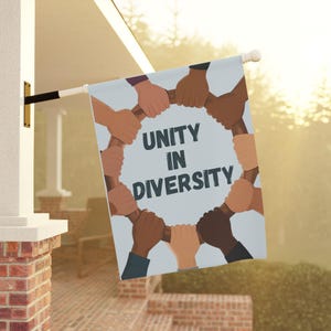 May include: A blue and white flag with a circle of hands of different skin tones holding each other. The text "Unity in Diversity" is inside the circle.