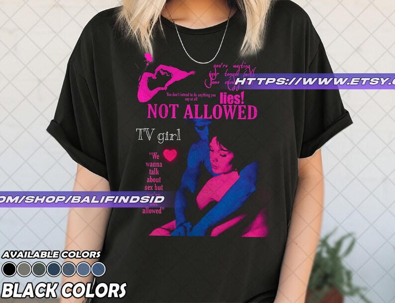May include: Black t-shirt with a graphic design featuring the text "NOT ALLOWED" and "TV girl". The design includes a pink and blue illustration of two figures embracing. The shirt also has the text "We wanna talk about sex but allowed".
