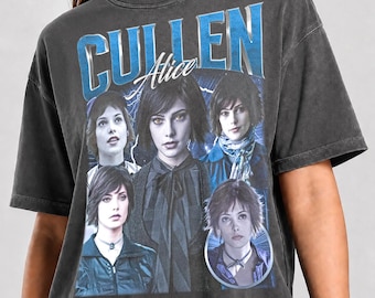 May include: A charcoal gray short-sleeve t-shirt featuring a graphic print of the character Alice Cullen. The design includes the text CULLEN and Alice in blue and white lettering, along with multiple photographic portraits of the character.