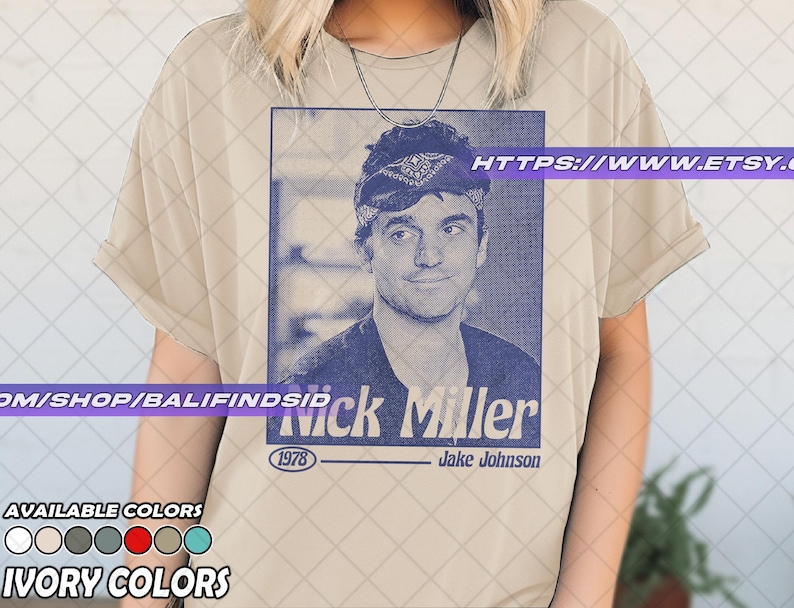May include: Ivory-colored t-shirt featuring a blue graphic of Nick Miller with the text "Nick Miller" and "1978". The shirt also displays the text "Jake Johnson" and "Available Colors" with color swatches. The Etsy shop URL is visible.