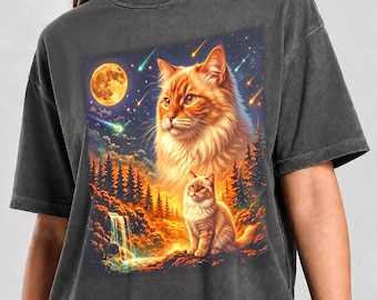 May include: A charcoal gray t-shirt featuring a graphic print of a large orange cat head above a smaller orange cat sitting near a waterfall and forest. The background shows a night sky with a full moon and shooting stars. Text reads Pepper Color.