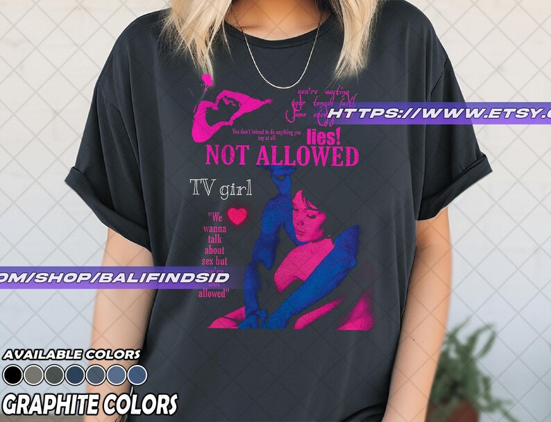 May include: A graphite-colored t-shirt with a graphic design featuring the text "NOT ALLOWED" and "TV girl." The design includes a pink and blue illustration of a person. The shirt also has the text "We wanna talk about sex but allowed."