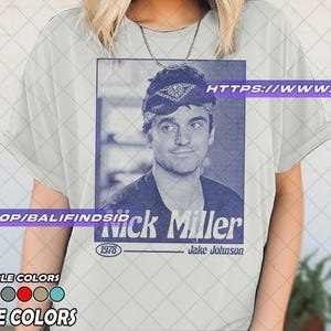 May include: A white ceramic mug with a black handle and the text "But First, Coffee" in a black, bold font. The mug is on a white surface.