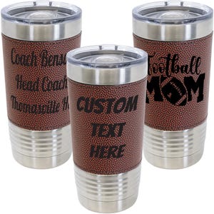 May include: Three stainless steel tumblers with a brown leatherette football pattern. The tumblers have black text that reads "Coach Bear Head Coach", "Football Mom", and "Custom Text Here".