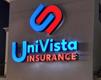 May include: A three-dimensional illuminated sign mounted on a wall featuring the text UniVista INSURANCE in blue and red lettering. Above the text is a stylised logo consisting of an interlocking blue and red shape resembling a link or chain.