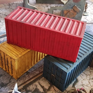 May include: Three stacked shipping containers, one red, one yellow, and one blue. The containers are made of metal and have a corrugated texture.