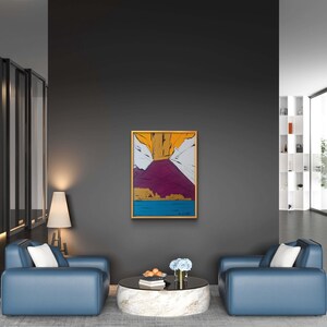 May include: Two blue armchairs with white cushions face each other in a modern living room. A round white coffee table with a glass top sits between them. A framed abstract painting with yellow, white, pink, and blue colors hangs on the wall behind the table.
