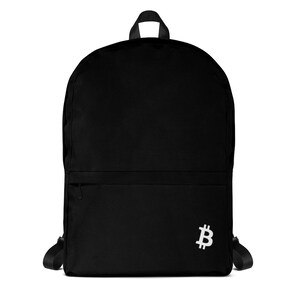 May include: Black backpack with a white Bitcoin symbol on the lower right. The backpack has a front zippered pocket, adjustable shoulder straps, and a top handle. The bag is made of a durable material.