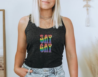 May include: A black tank top with the words "SAY GAY" in rainbow letters.