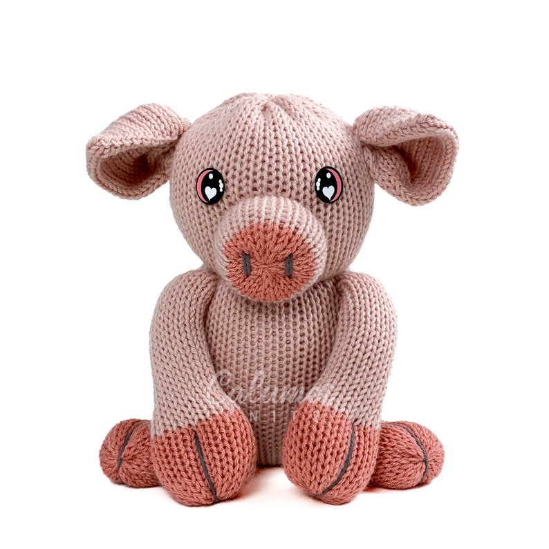 May include: A pink knitted pig toy with black eyes and a pink snout. The pig is sitting with its legs crossed.