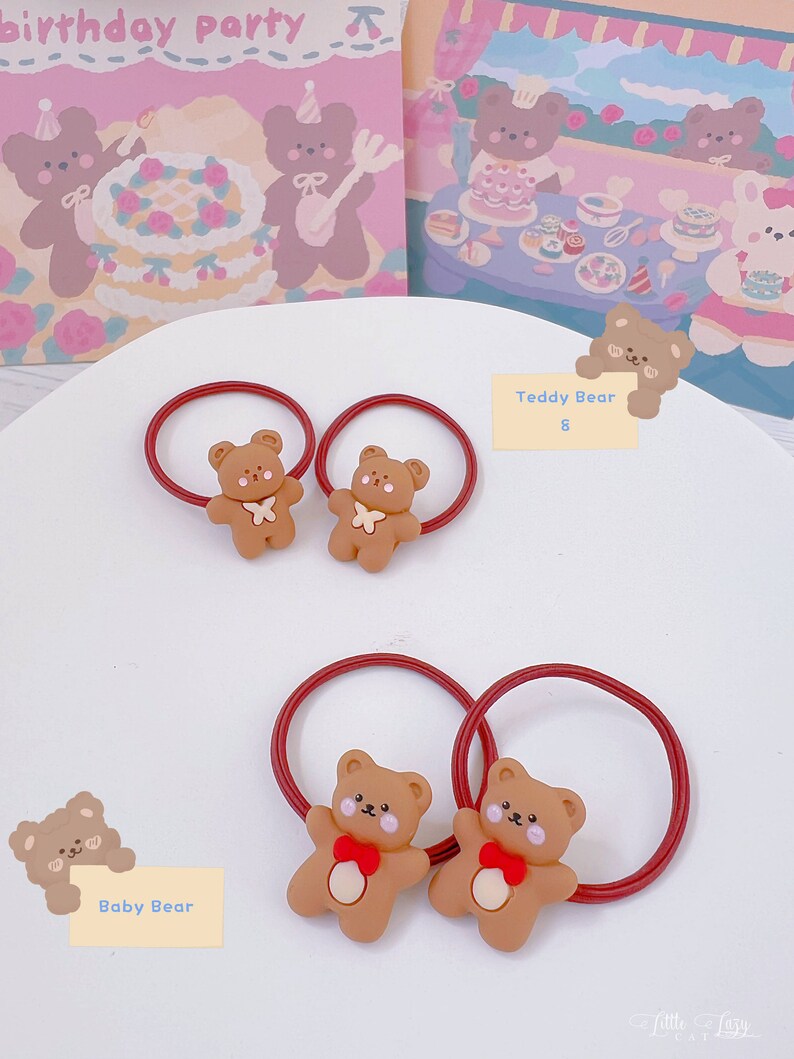 May include: Two sets of brown teddy bear hair ties with red elastic bands. One set has a white bow, the other has a red bow. The background includes illustrations of teddy bears and the words "birthday party".