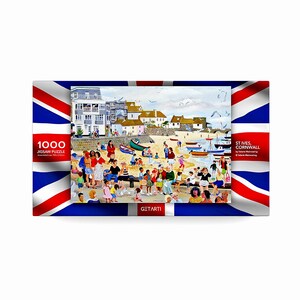 Może przedstawiać: Puzzle 1000-elementowe przedstawiające kolorową ilustrację sceny plażowej w St. Ives w Kornwalii. Puzzle przedstawia plażę z ludźmi, łodziami i mewami. Puzzle jest oprawione w flagę Unii Brytyjskiej.