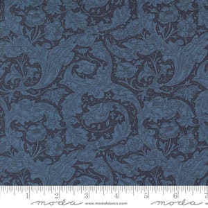 May include: Blue and gray floral fabric with a repeating pattern of stylized leaves and flowers. The fabric has a textured surface and a vintage aesthetic.