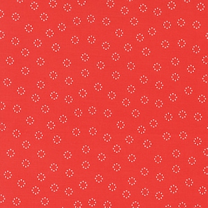 May include: Red fabric with a white dotted pattern of small circles. The circles are arranged in a repeating pattern.