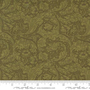 May include: Green fabric with a repeating pattern of stylized leaves and flowers. The fabric has a textured, almost embossed look. The fabric is measured with a ruler that reads "moda" and includes the website www.modafabrics.com.