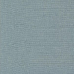 May include: A close-up of a plain, pale blue fabric with a fine woven texture. The material has a matte appearance and seems to be of medium weight, appropriate for diverse sewing applications. The colour is a soft, muted blue.