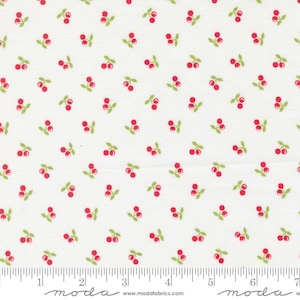 May include: White fabric with a repeating pattern of red cherries and green leaves. The cherries are small and evenly spaced across the fabric. The fabric has a ruler printed along the bottom edge.