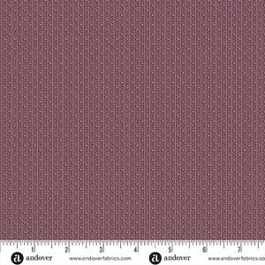 May include: A mauve fabric featuring a repeating pattern of vertical stripes composed of small dots and thin lines. A white ruler at the bottom edge shows measurements in inches, indicating the scale of the textile design.
