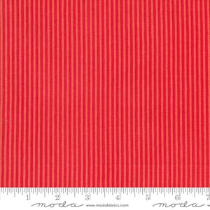 May include: Close-up of a red fabric with vertical stripes in varying shades of red. The stripes are evenly spaced and run the length of the fabric. A ruler is at the bottom of the image, with the word "moda" printed on it.